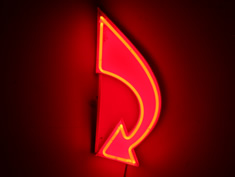curved red neon arrow
